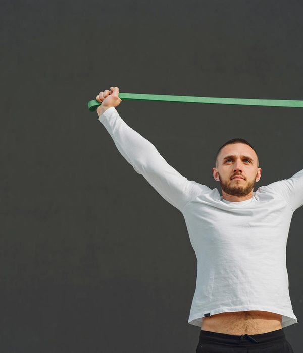 Man performing functional strength exercises in a modern training space.